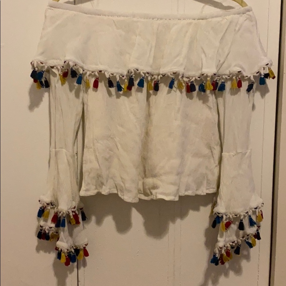 Cream off the shoulder top with tassel detailing